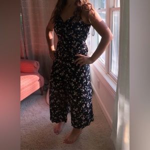 Black jumpsuit with white and pink flowers